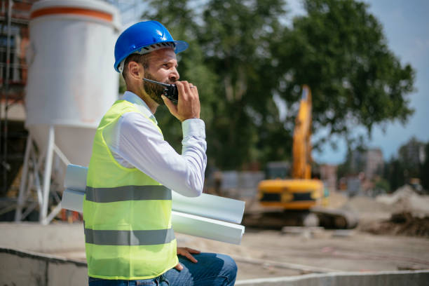 istock Young architect with blueprint and blue helmet 1069800526