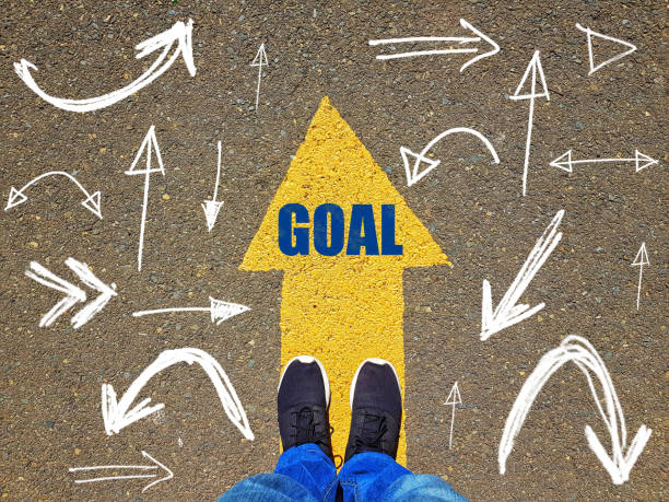 istock low section of a man standing on yellow arrow on asphalt ground 1069800854