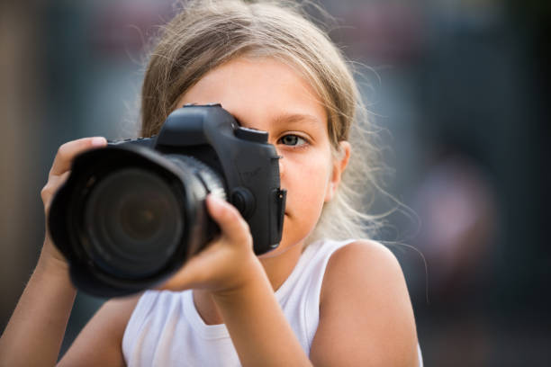 istock girl holding photo camera 1069806800