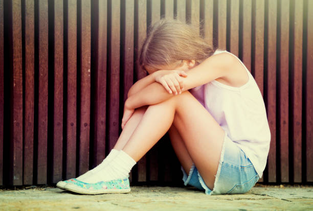 istock sad girl outdoors 1069807068