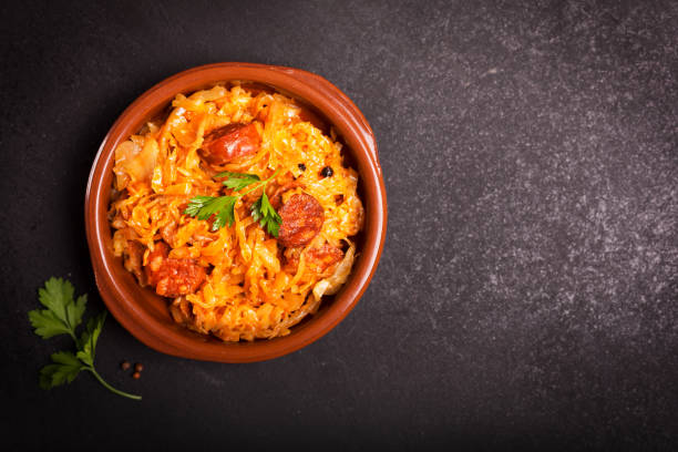 istock Bigos, a traditional Polish dish with cabbage on dark background with copy space 1069809614
