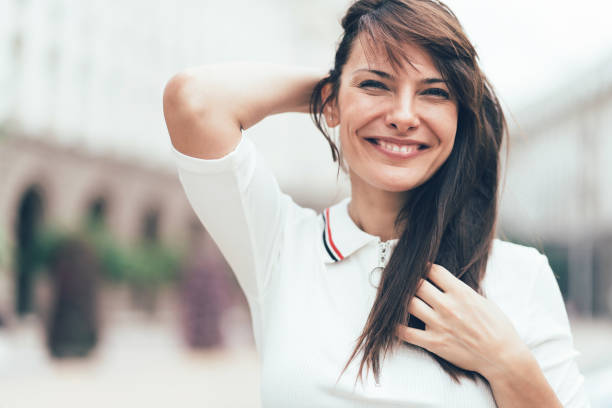 istock Smiling woman with hands in hair 1069812556