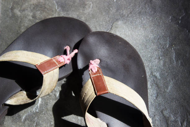 istock Pair of flip flops on concrete floor 1069815420