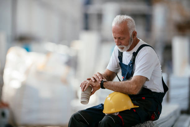 istock Senior factory worker having coffee break 1069833476
