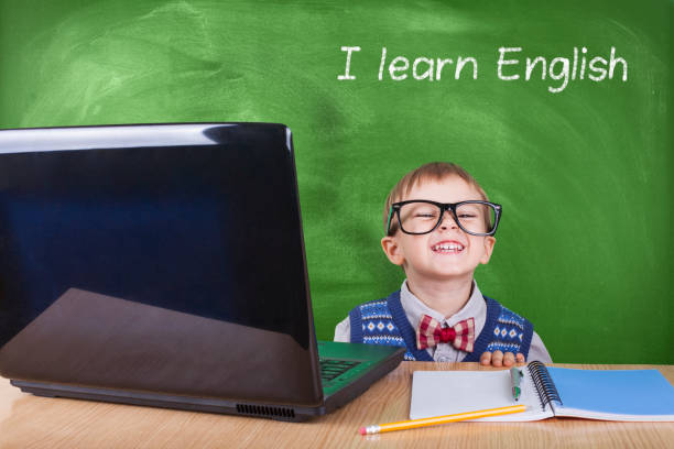 istock Child with laptop peeking in the classroom 1069837136