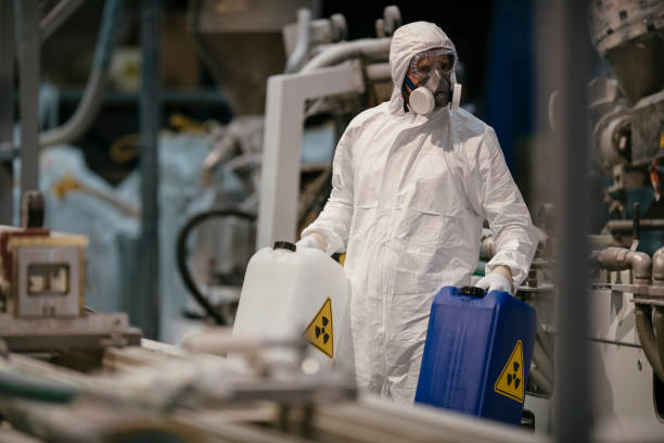 istock Factory worker wearing gas mask and radioactive protection suit 1069839046