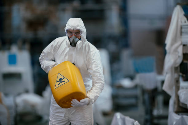 istock Factory worker wearing gas mask and radioactive protection suit 1069840584