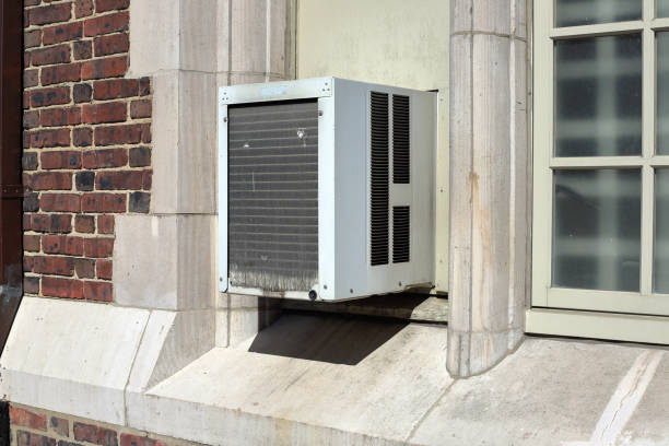 istock Window Air conditioner unit on brick building used for cooling 1069841262