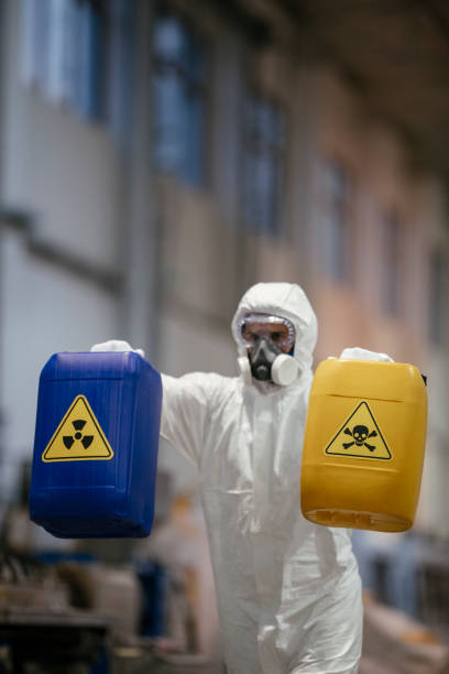 istock Factory worker wearing gas mask and radioactive protection suit 1069842584