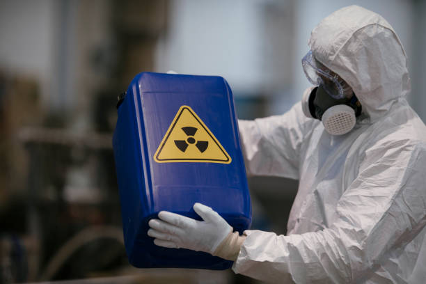 istock Factory worker wearing gas mask and radioactive protection suit 1069842850