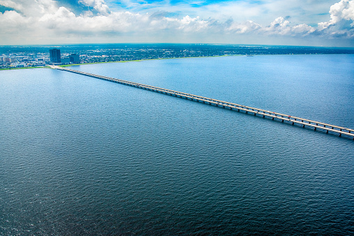 The beginning of the Lake Pontchartrain Causeway, the worlds longest bridge at just under 24 miles long, at Metarie, Louisiana and shot from an altitude of about 1000 feet during a helicopter photo flight.