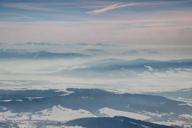 Photo of Winter scenery with foggy blue ridges and valleys in Oravska Magura Chocske vrchy Nizke Tatry ranges, Orava Liptov Slovakia Central / Eastern Europe