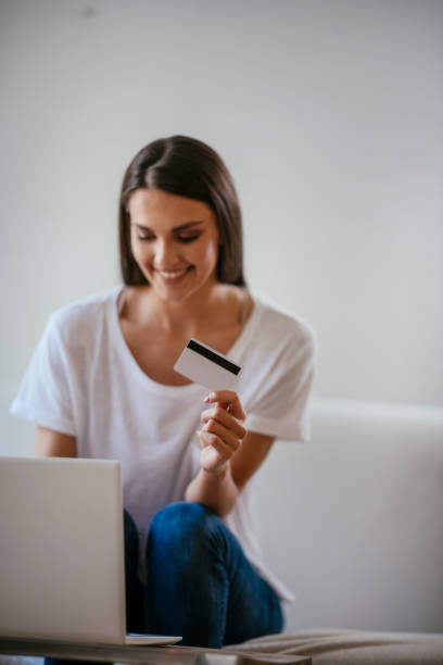 istock Beautiful young woman purchasing online 1069847976