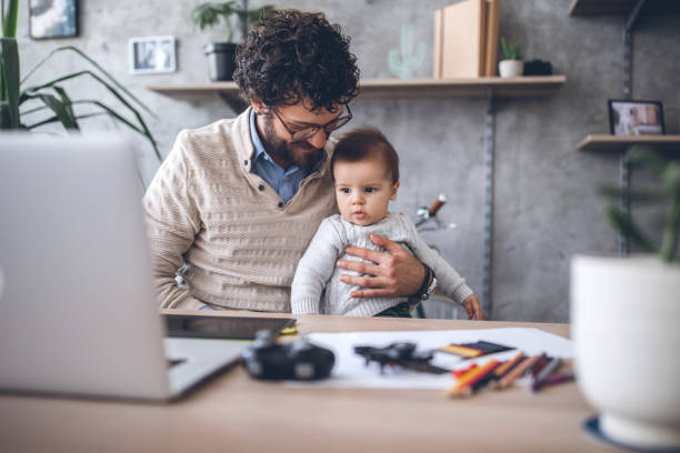 istock Both Father And Baby Looking At Laptop 1069854286