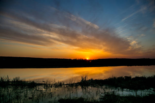 istock Spring dawn on the river Don is reflecting in calm water 1069856608