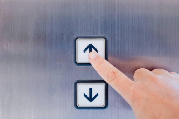 Hand pressing the button in the elevator Hand pressing the button in the elevator in front view hand elevator stock pictures, royalty-free photos & images