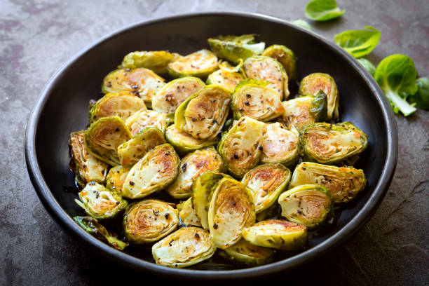 istock Roasted Brussel Sprouts in Black Bowl over Slate 1069858726