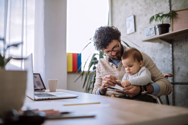 istock Single Father And Baby in home office 1069859184