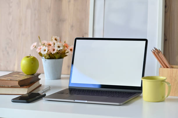 istock Mockup blank screen laptop, blank poster on white desk, Workspace concept 1069862774