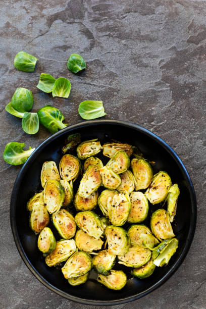 istock Roasted Brussel Sprouts in Black Bowl over Slate Top View 1069863732