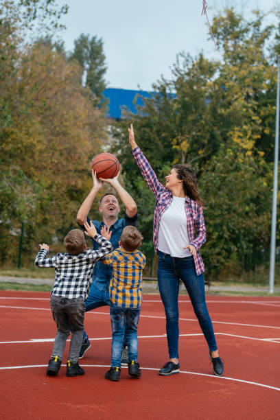 istock Family having fun time at basketball field 1069871220