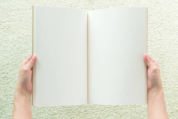 istock Human hands holding blank open book mock up, catalog ,magazines, brochure or note template with paper texture copyspace 1069877650