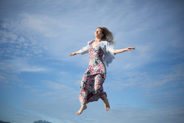 istock Young woman making a funny face while jumping humour 1069877938