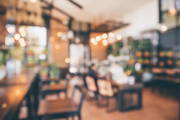 istock Restaurant cafe or coffee shop interior with customer blur abstract vintage style bokeh light for montage product display background 1069879160