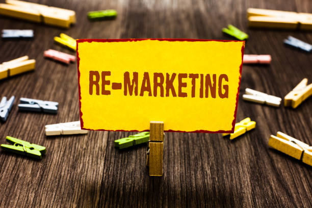 istock Handwriting text writing Re Marketing. Concept meaning Strategy to reach potential customers in your website Clothespin holding yellow paper note several clothespins wooden floor. 1069879384