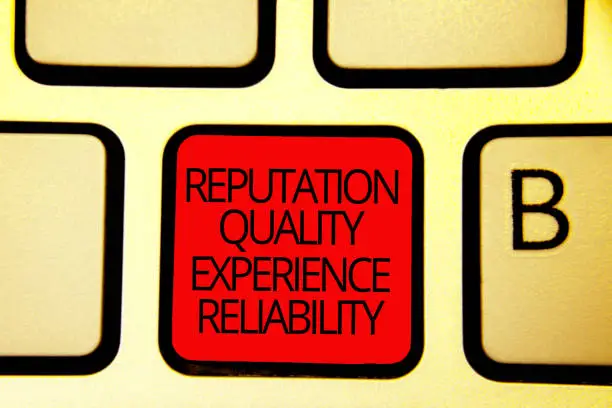 Photo of Text sign showing Reputation Quality Experience Reliability. Conceptual photo Customer satisfaction Good Service Keyboard red key Intention create computer computing reflection document.