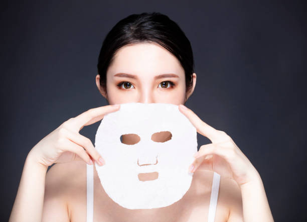 istock closeup young beauty face and facial mask 1069891020