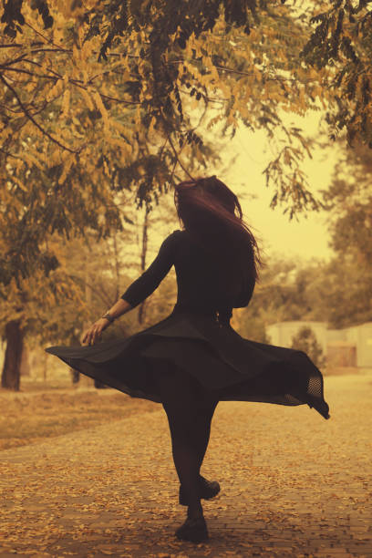 istock Girl in autumn park 1069892316