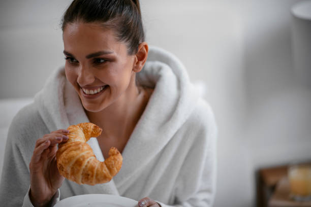 istock Young women having croissant 1069892406