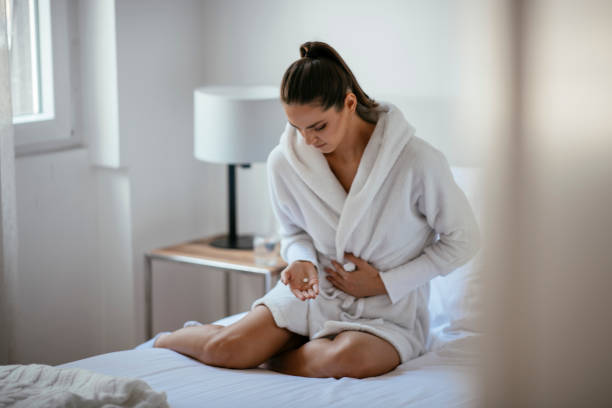 istock Woman with a stomach ache 1069895706