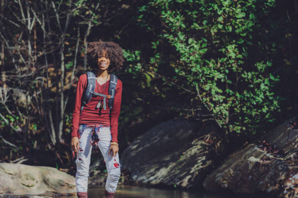 istock woman hiking by the river 1069895766