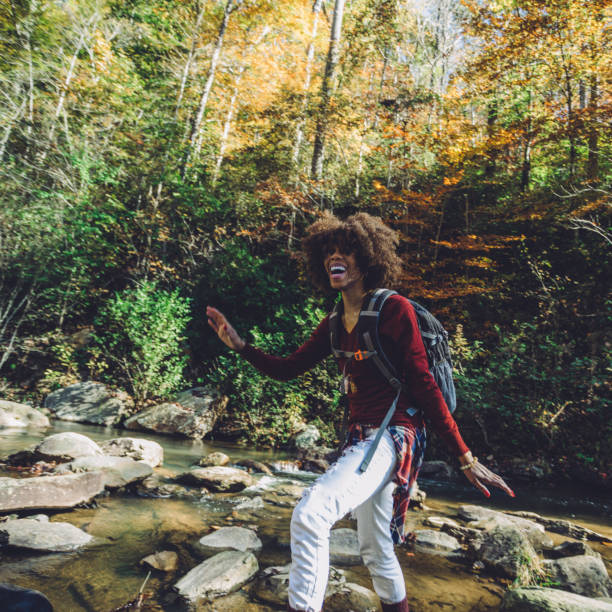 istock woman hiking by the river 1069895836