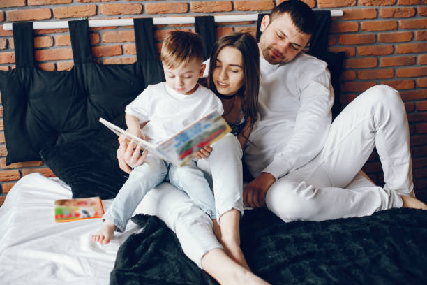 istock Family sitting in a bed 1069896952