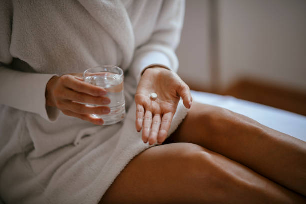 istock Beautiful woman having pills 1069897108