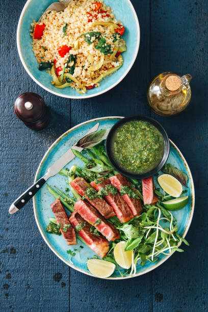 istock Steak with mustard sauce, vegetables, herbs and capers 1069897384