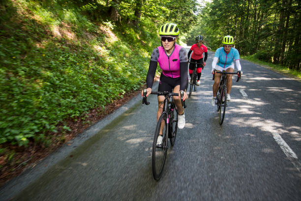istock Three women riding road bikes on mountain road 1069897624