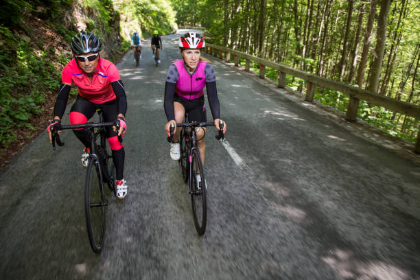 istock Two women riding road bikes on mountain road 1069897628