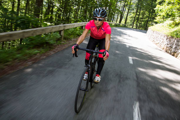 istock Woman riding road bikes on mountain road 1069897652