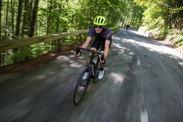 istock Man riding road bikes on mountain road 1069897656