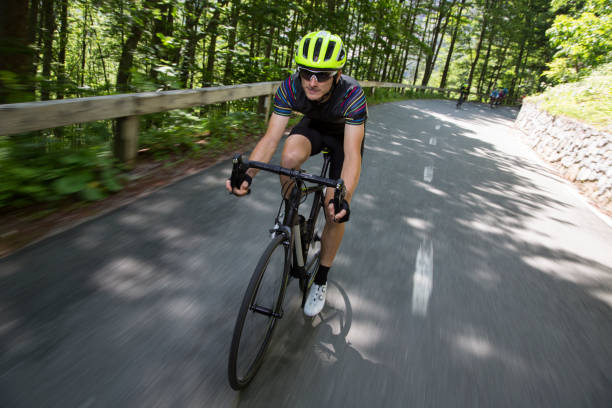 istock Man riding road bikes on mountain road 1069897658