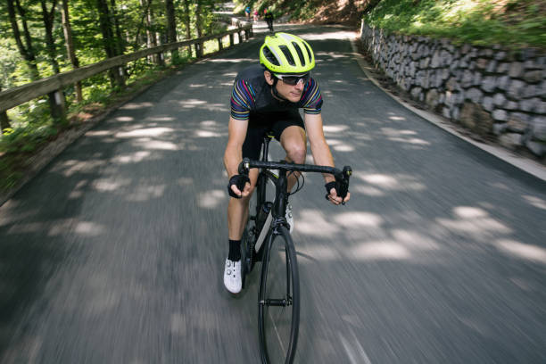 istock Man riding road bikes on mountain road 1069897664