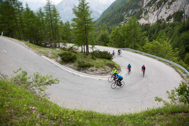 istock Group of road cyclists riding up mountain road 1069897692