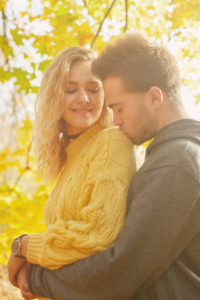 istock Young couple in love in autumn forest 1069903678