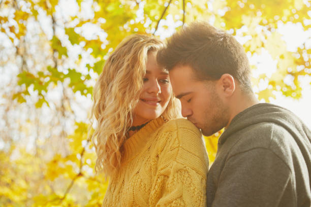 istock Young couple in love in autumn forest 1069903682