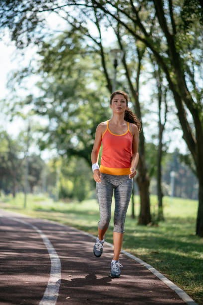istock Young woman running outdoors 1069905076