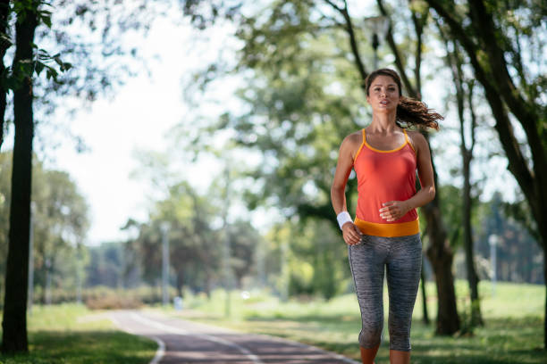 istock Young woman running outdoors 1069911540